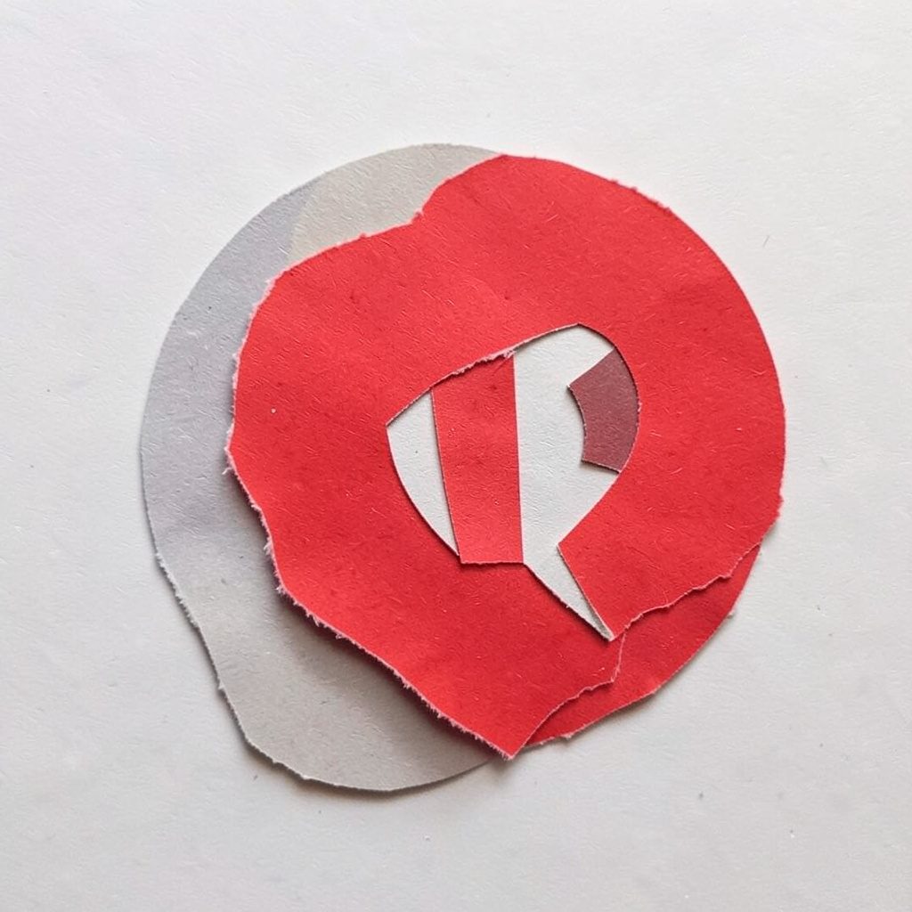 A layered paper cut-out collage of a stylised camera aperture, warm terracotta and cream tones